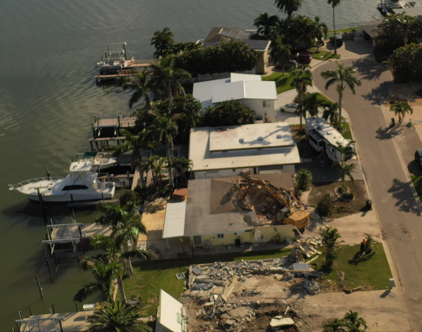 Aerial view of a waterfront residential demolition in progress